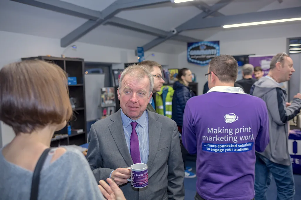 Customers and HAD-COPY team members talking at a workplace print event